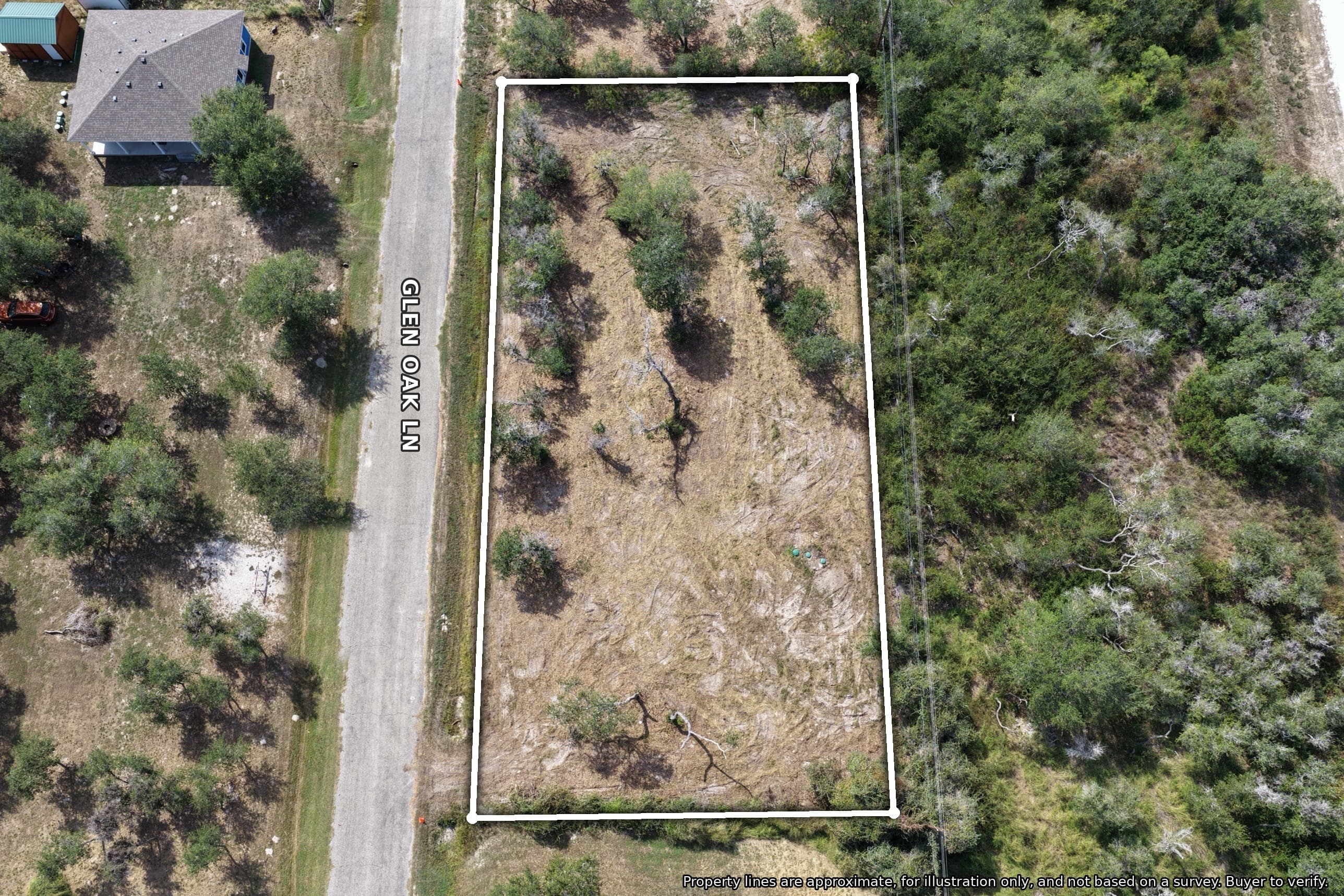 Aerial view of a rectangular land parcel outlined in white bordering Glen Oak Lane.