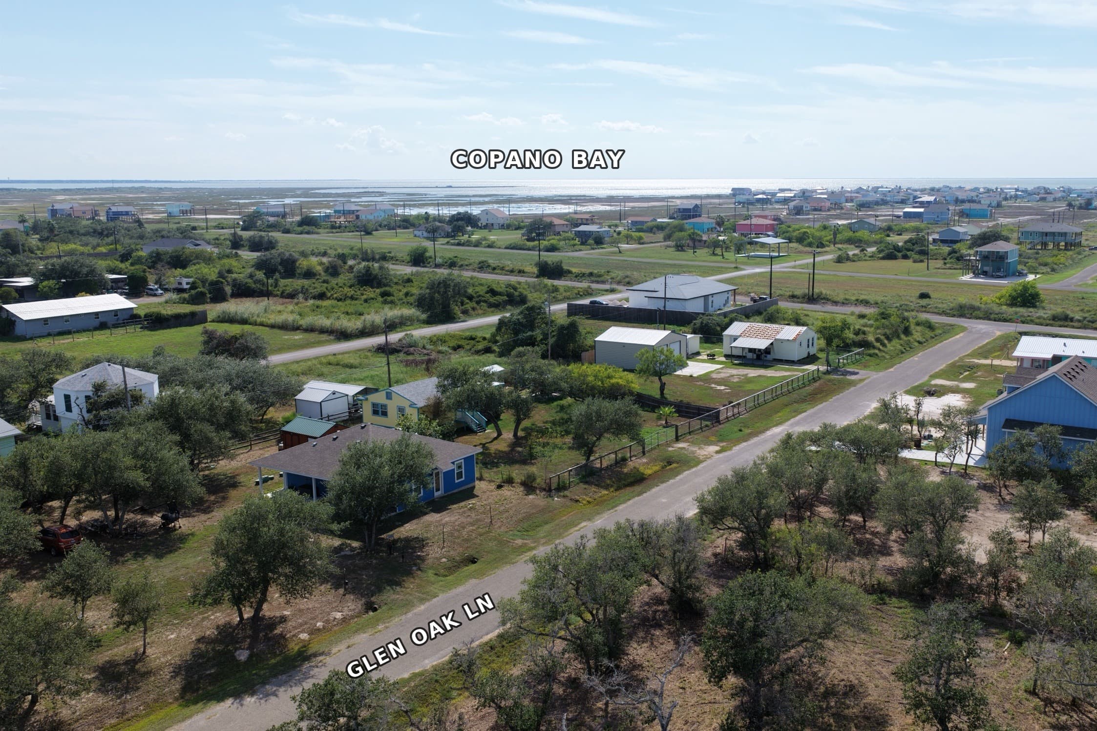 Aerial view of houses along Glen Oak Lane with Copano Bay in the distance.